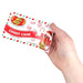 Hand holding a Jelly Belly Candy Cane jelly bean package against a white background