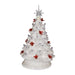 “14.25-inch iridescent white ceramic Christmas tree, pre-lit from within, decorated with red cardinal bird accents and topped with a star, standing on a flat base. Lights off 
