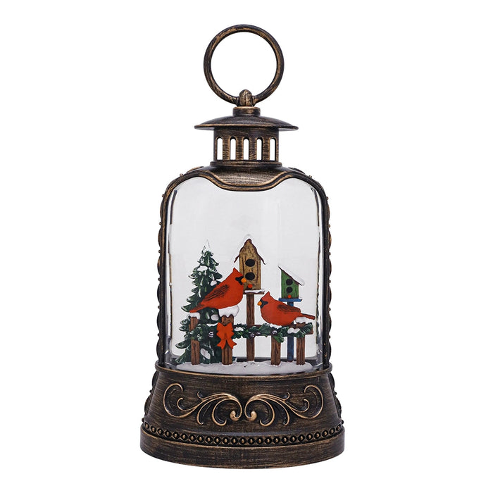 Decorative lantern with a winter scene featuring cardinals and a birdhouse.