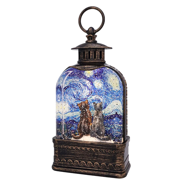 Decorative lantern with a glass insert showing two cats under a starry night sky design.