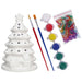 White ceramic Christmas tree with paintbrushes, paint, and colored beads on a white background