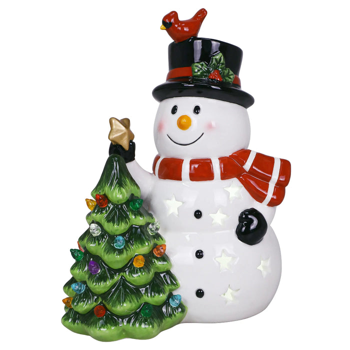 Decorative snowman figurine with a small tree and bird on a white background
