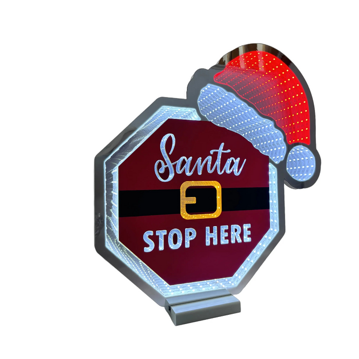 Decorative sign with Santa hat design and 'Santa Stop Here' text on a white background