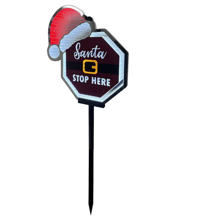 Decorative sign with Santa hat and 'Santa Stop Here' text on a white background
