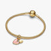 A heart charm embellished with bright pink enamel, highlighting its delicate and attractive design.