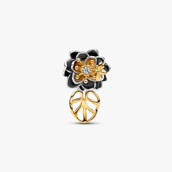 Close‑up of Disney’s Tiana Water Lily charm with lab‑grown diamond, firefly, and dangling leaf