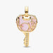 Gold pendant with pink heart design on a white background