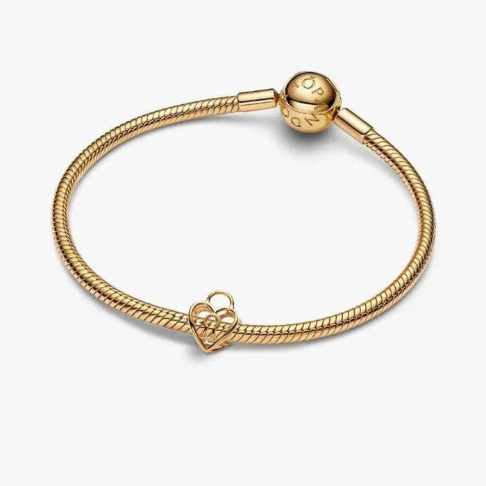 Gold bracelet with a heart-shaped clasp on a white background