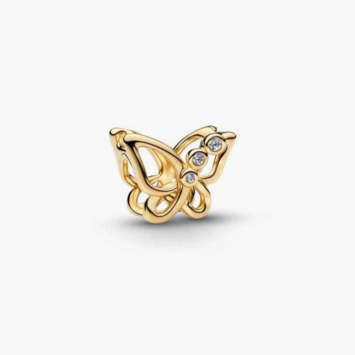 Golden butterfly-shaped charm on a light background