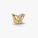 Golden butterfly-shaped charm on a light background