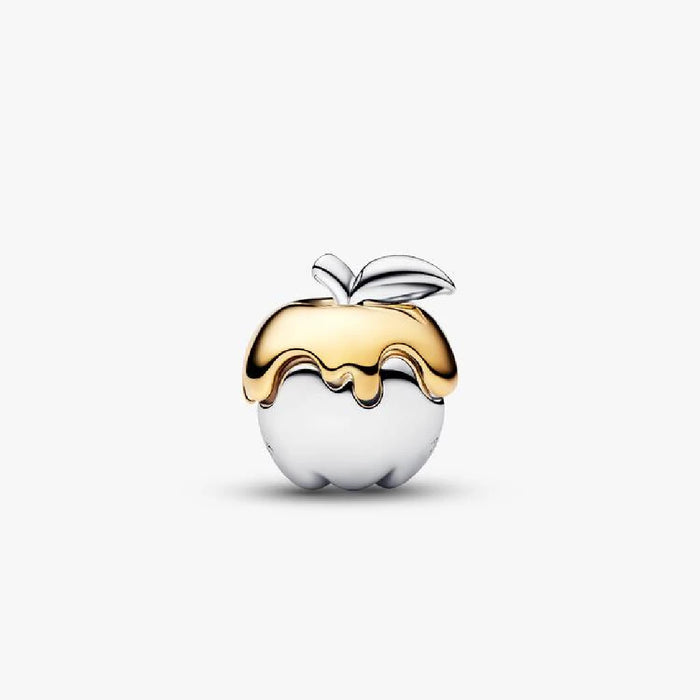 A close-up of a Pandora charm shaped like an apple, representing themes of education and desire.