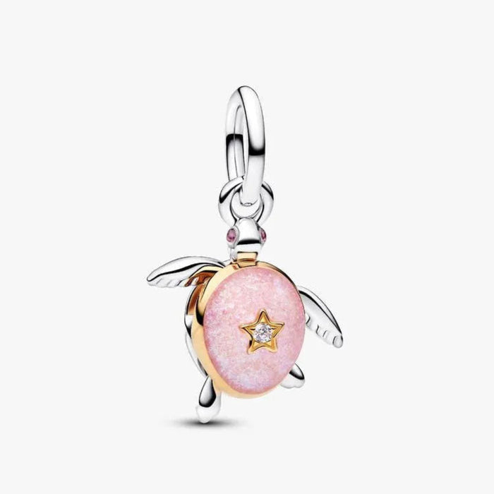 Pink turtle charm with a star detail on a white background