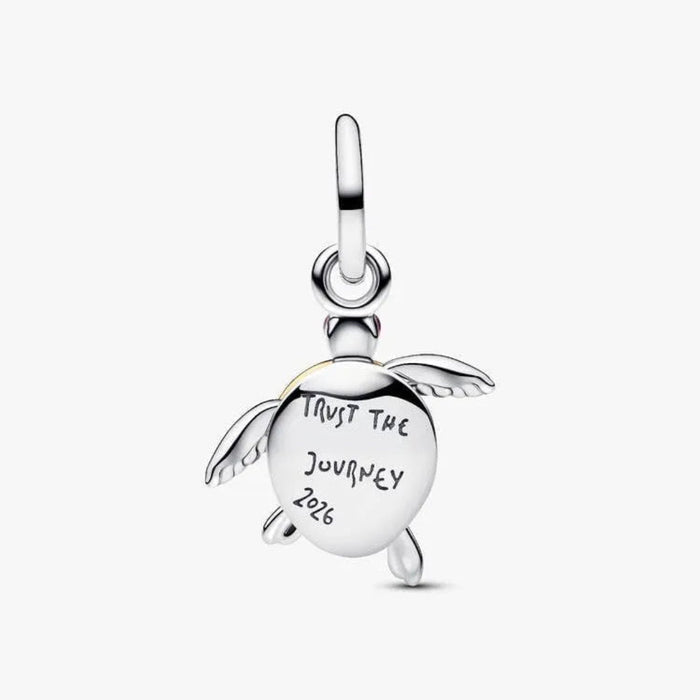 Silver turtle charm with 'Trust the Journey 2026' engraving on a white background
