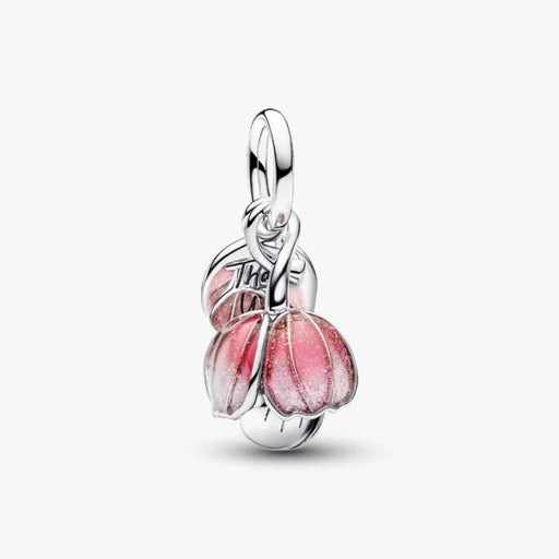 Silver flower-shaped charm on a light background