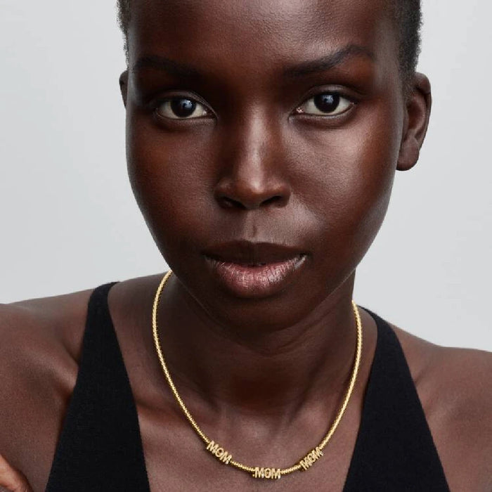 A diamond-studded yellow gold ring, rhodium plated, symbolizing the timeless love of a mother.