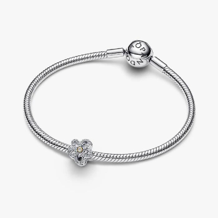 A diamond flower charm on a white background, emphasizing its delicate features and shimmering facets.