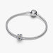 A diamond flower charm on a white background, emphasizing its delicate features and shimmering facets.