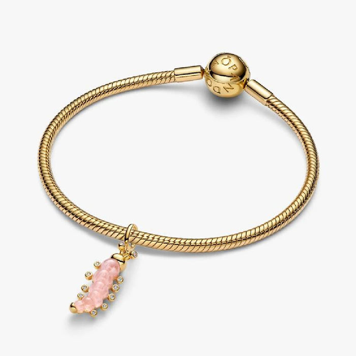 Elegant gold chain with a pink stone charm, accented by shimmering diamonds.