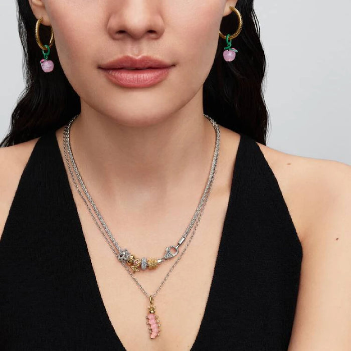 Pink stone charm with diamond accents, suspended from a luxurious gold chain.