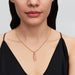 Gold chain showcasing a pink stone charm, beautifully set with diamonds.