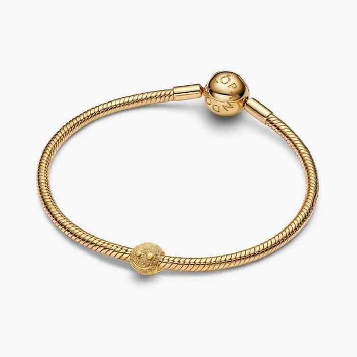 Gold bracelet with a rope design on a white background