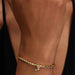 A charming gold plated rose with pink stones, highlighting a graceful and romantic aesthetic in jewelry.