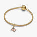 Gold-tone American flag dangle charm adorned with red, white, and blue crystal accents, designed for charm bracelets