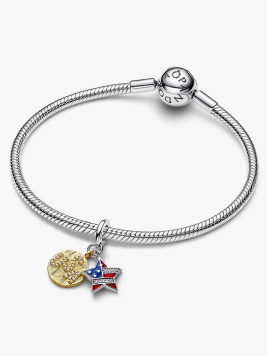 Sterling silver-tone dangle charm featuring a red, white, and blue enamel star with crystal accents and a gold-tone heart, designed for charm bracelets and necklaces.