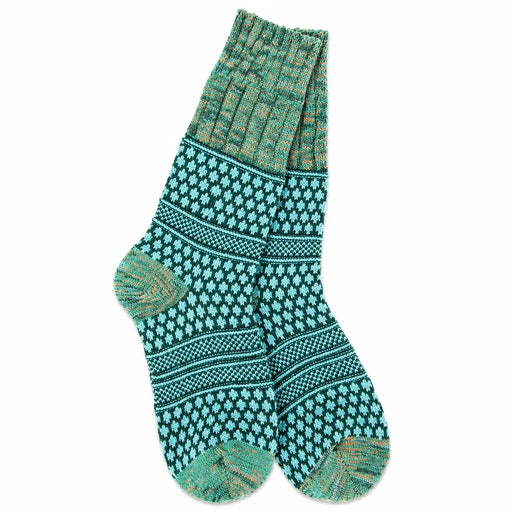 A pair of hand-knit socks featuring a teal and green Nordic/Fair Isle pattern with subtle orange-brown accents, displayed against a solid white background.