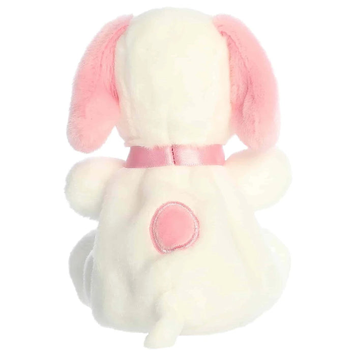 A white plush animal with pink ears, placed on a simple, light-colored surface.