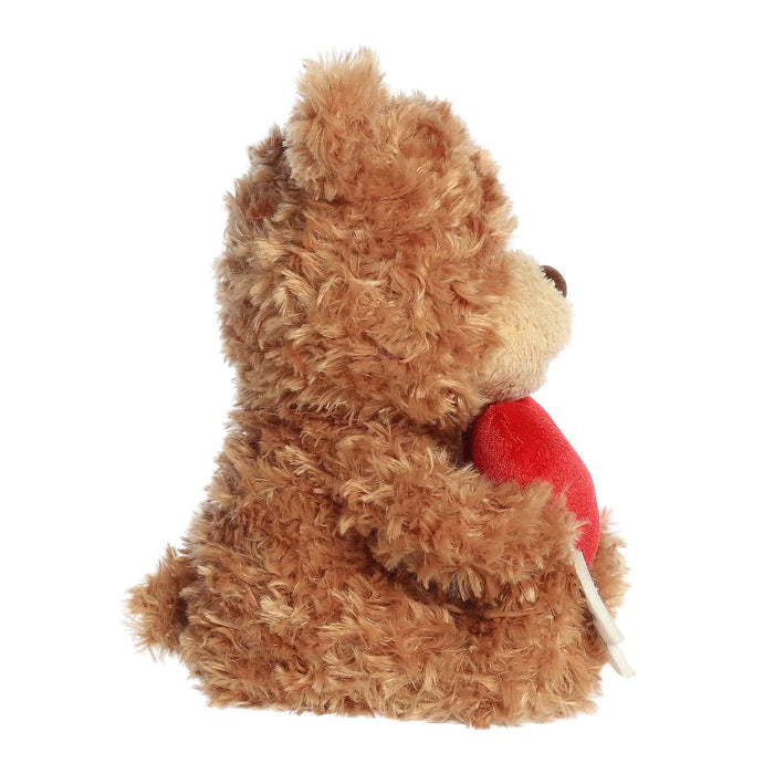 A plush brown teddy bear with a heart and arrow, illustrating a theme of romance and affection.