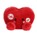 A red heart-shaped pillow adorned with various lipstick kisses, symbolizing love and affection.