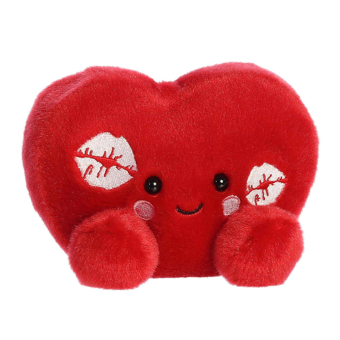 A vibrant red heart pillow featuring playful lipstick kiss marks, representing romance and tenderness.