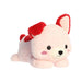 A plush pink toy with a bright red collar, positioned on a soft surface.