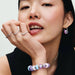 This Pandora Opalescent Purple Charm adds an enchanting pop of color to your jewelry collection.