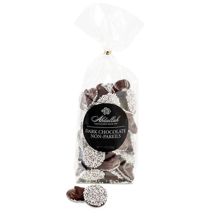 Abdallah Candies Dark Chocolate Non-Pareils featuring rich dark chocolate topped with crisp white candy seeds.