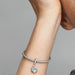 Elevate your love for your best friend with the Sparkling Pet Paw Print Dangle Charm.