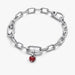 Silver chain bracelet with a red heart charm on a white background