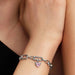 Winged heart mini dangle charm with pink crystal worn on a bracelet 