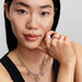 Close‑up of a necklace featuring the polished asymmetric heart charm alongside coordinating charms