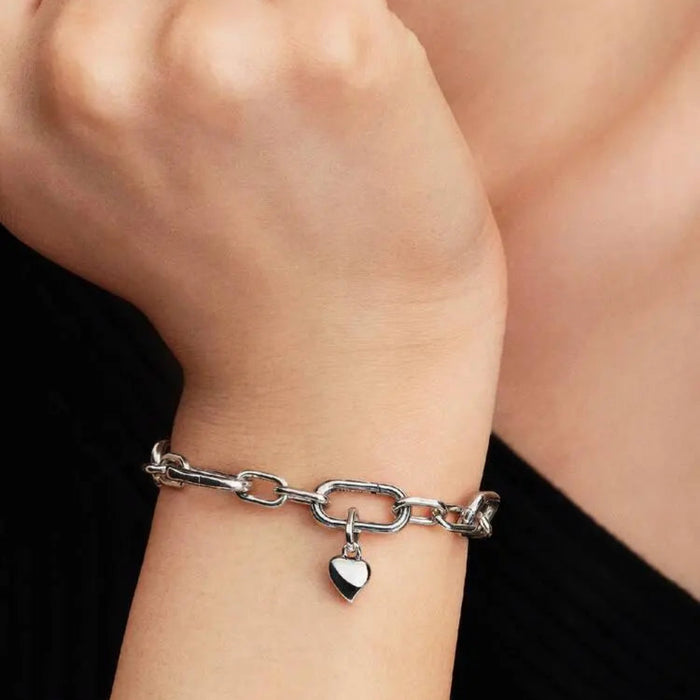 Asymmetric sterling silver heart mini dangle charm worn on a chain 