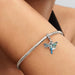 PANDORA Dragonfly Double Dangle Charm in sterling silver with transparent and holographic glitter enamel wings, sparkling stone eyes, and a “Free Spirit” engraved disc for PANDORA Moments bracelets.