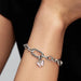 Exquisite Pandora butterfly charm with a white opal, reflecting light and showcasing a refined design.