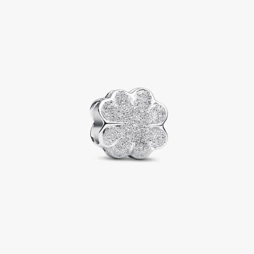 Silver four-leaf clover charm on a white background