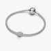 Silver bracelet with a textured charm on a white background