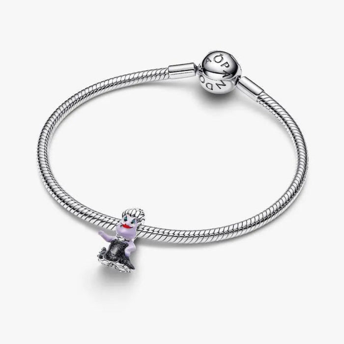Silver bracelet with a heart-shaped charm on a white background