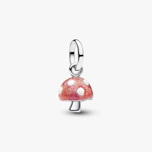 Mushroom-shaped charm with red and white polka dot design on a white background
