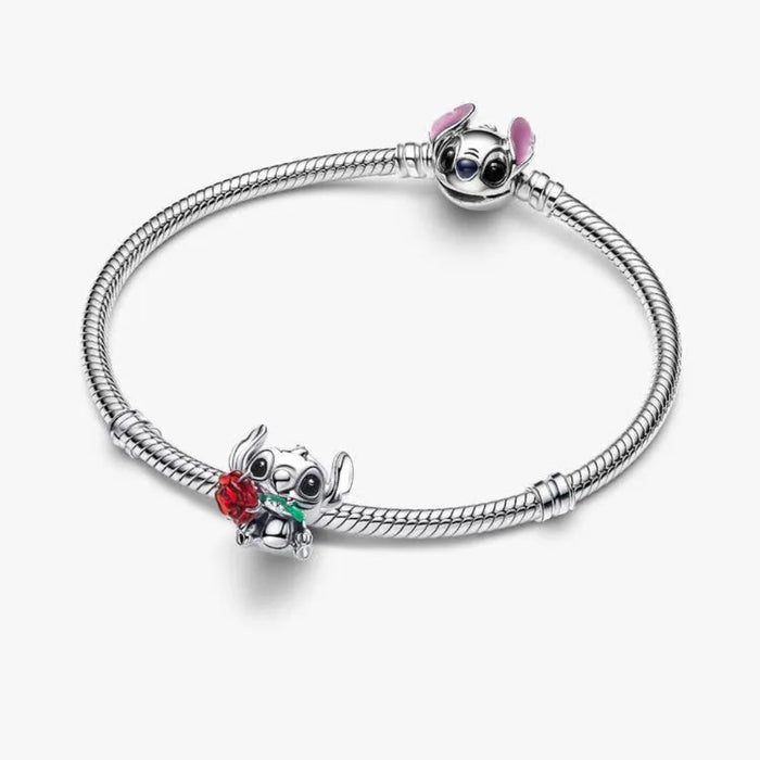 Silver bracelet with two charms on a white background