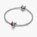 Silver bracelet with two charms on a white background