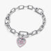 Silver chain bracelet with a pink heart-shaped charm on a white background